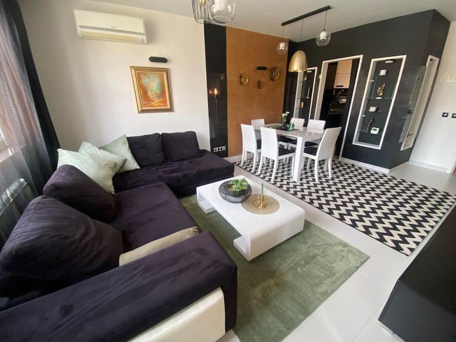 a living room with a couch and a table at Lovely 1-bedroom apartament with free parking in Sofia