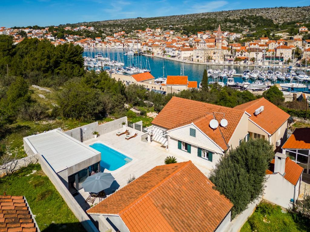 an aerial view of a house with a marina at Villa TM with private heated pool, poolhouse & private garage in Milna