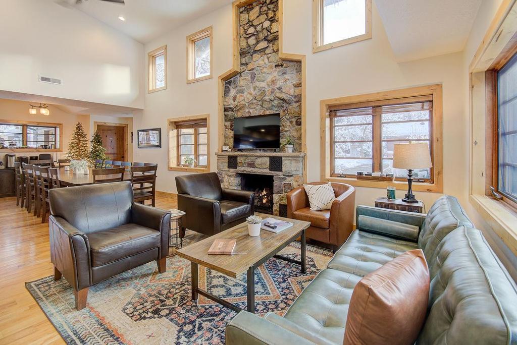a living room with leather furniture and a stone fireplace at Engen Hus Bed and Breakfast in Salt Lake City