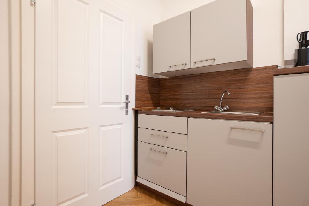A kitchen or kitchenette at Modern hotel-styled apartment in the second district of Vienna.