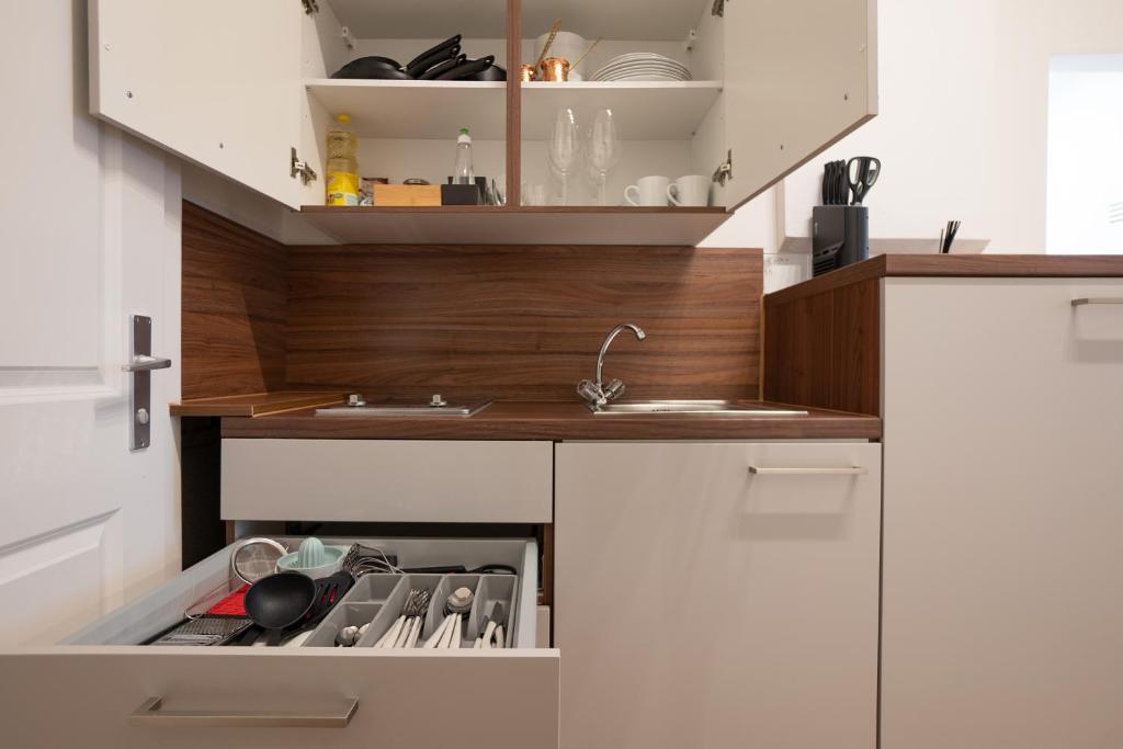 A kitchen or kitchenette at Modern hotel-styled apartment in the second district of Vienna.