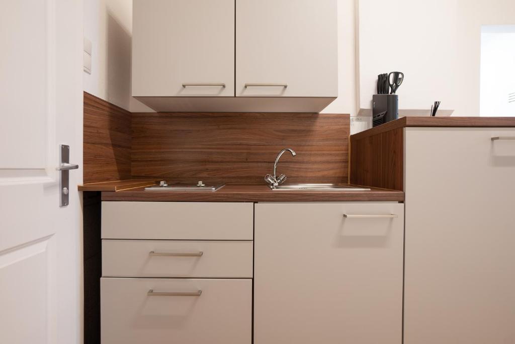 A kitchen or kitchenette at Modern hotel-styled apartment in the second district of Vienna.
