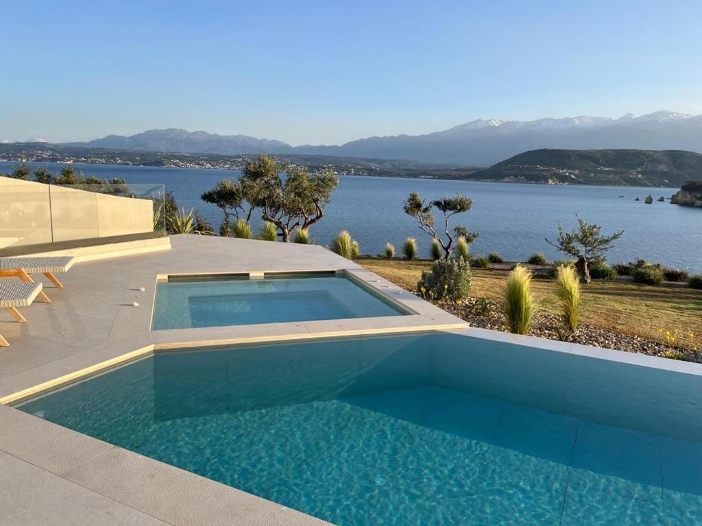 a swimming pool with a view of the water at Vicky's Island View in Marathi