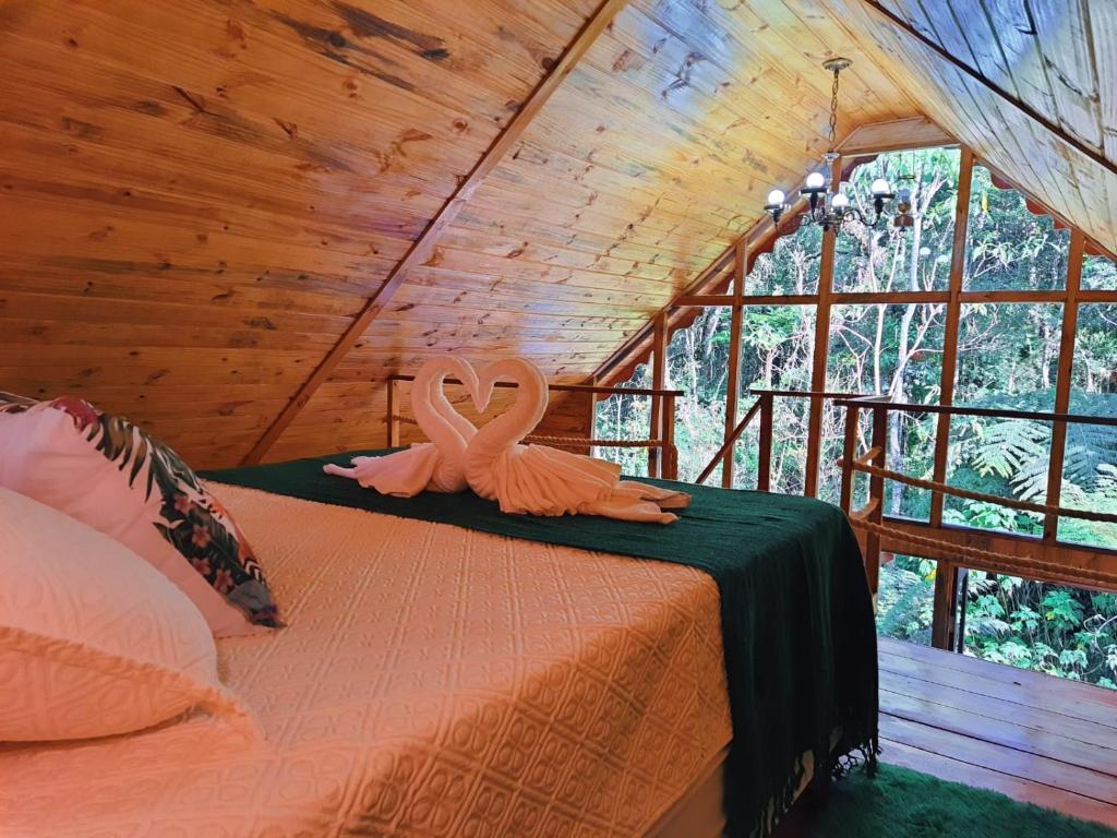 Tempat tidur dalam kamar di Chalé Samambaia