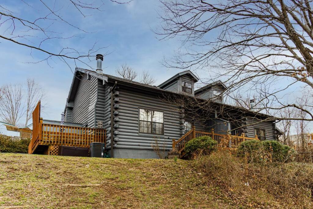 a log house with a porch on a hill at 3 Bedroom Log Cabin Condo close to Everything! in Branson