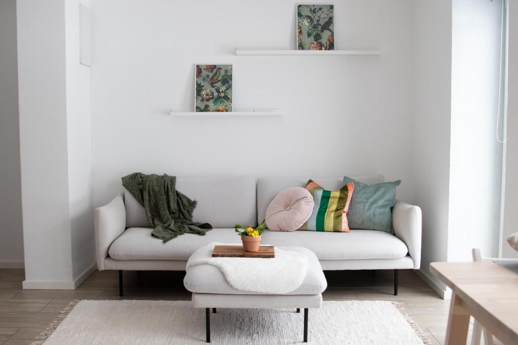 a living room with a couch and a table at Modern and cosy apartment in Lahemaa national park in Kolga