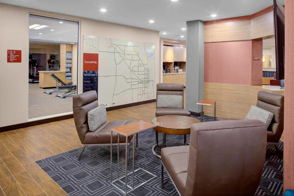 a waiting room with chairs and a map at TownePlace Suites by Marriott Albany in Albany