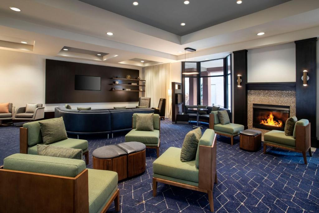 a lobby with a waiting room and a fireplace at Courtyard Worcester in Worcester