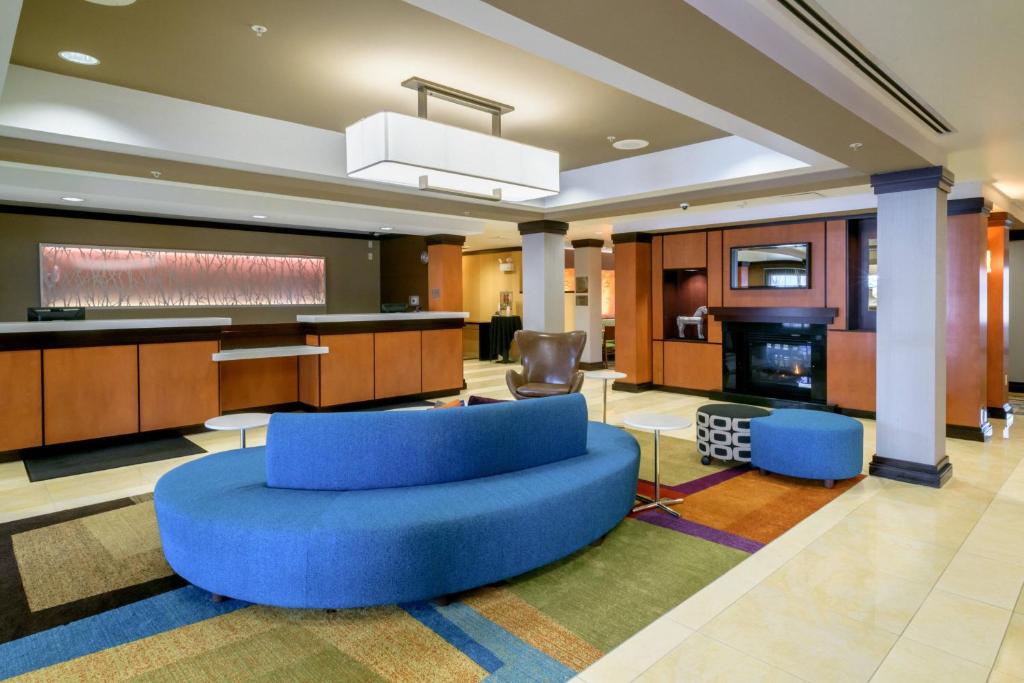 a large lobby with a blue couch and chairs at Fairfield Inn & Suites Kennett Square in Kennett Square