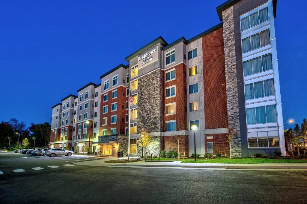 a row of apartment buildings on a street at night at Residence Inn by Marriott Blacksburg-University in Blacksburg