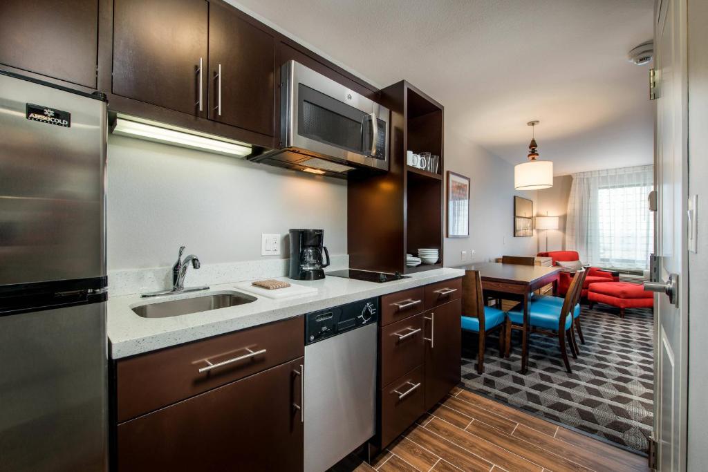 a kitchen with a sink and a table in a room at TownePlace Suites by Marriott Waco South in Waco