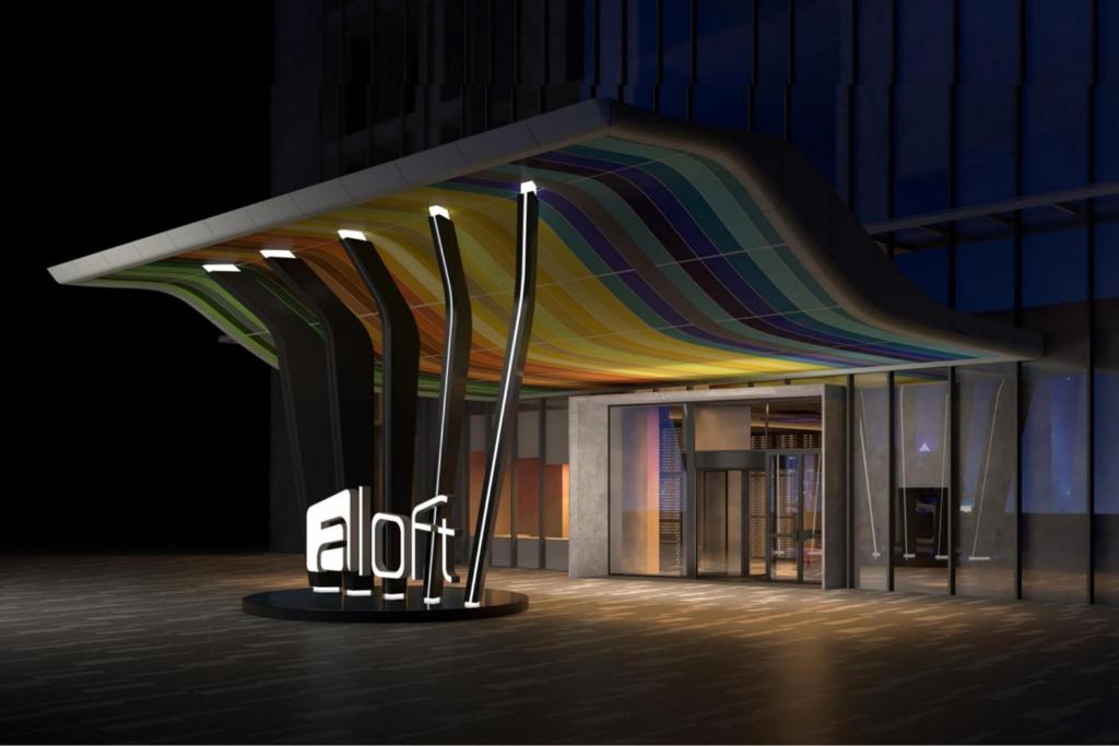 a building with a rainbow canopy in front of it at Aloft Shijiazhuang in Shijiazhuang