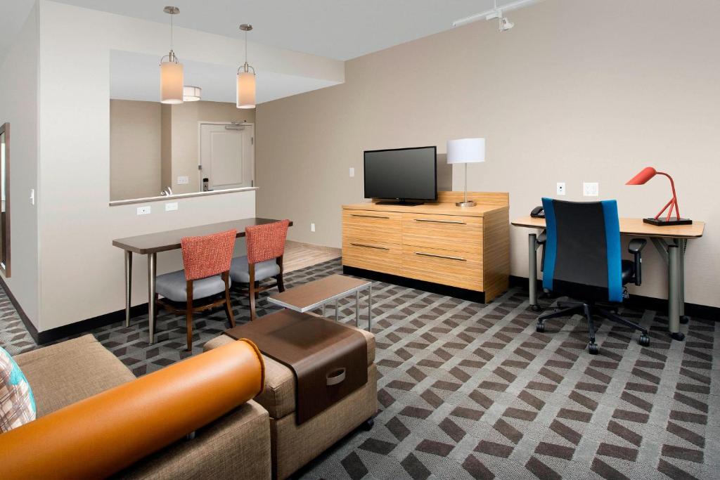 an office with a couch and chairs and a tv at TownePlace Suites by Marriott Alexandria Fort Belvoir in Woodlawn