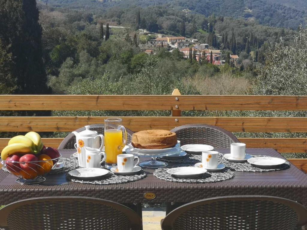 a table with a breakfast of orange juice and bread at Dream House 