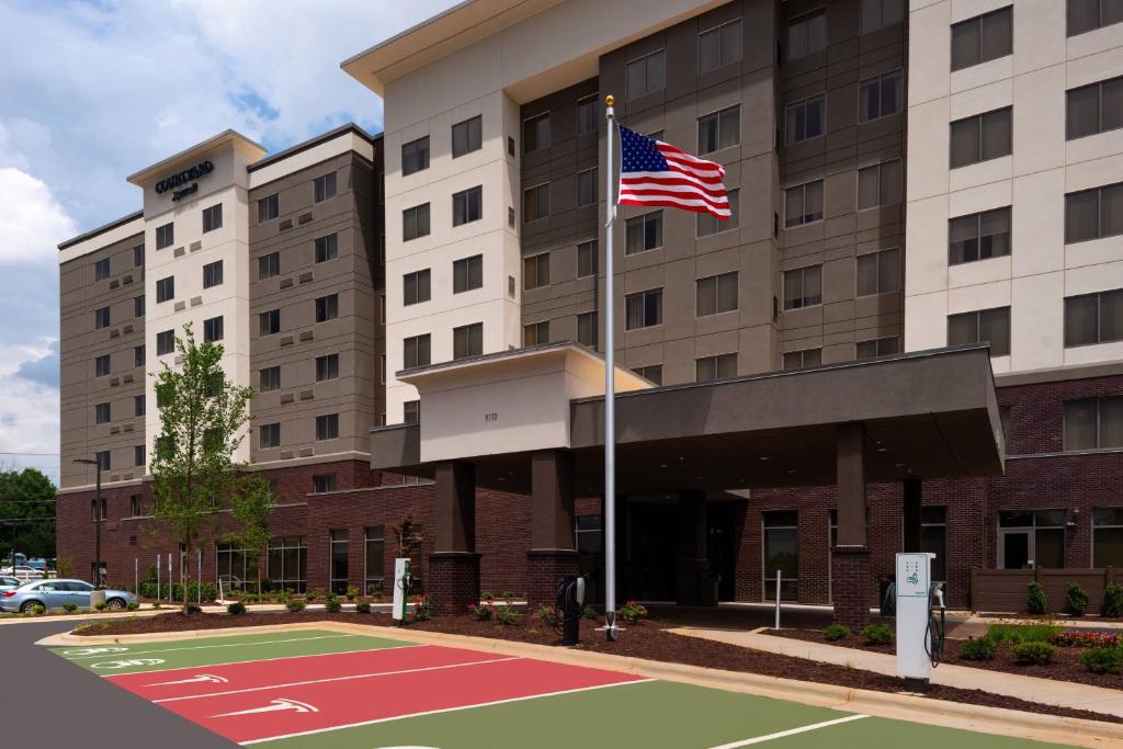 an american flag on a basketball court in front of a hotel at Courtyard by Marriott Charlotte Northlake in Charlotte