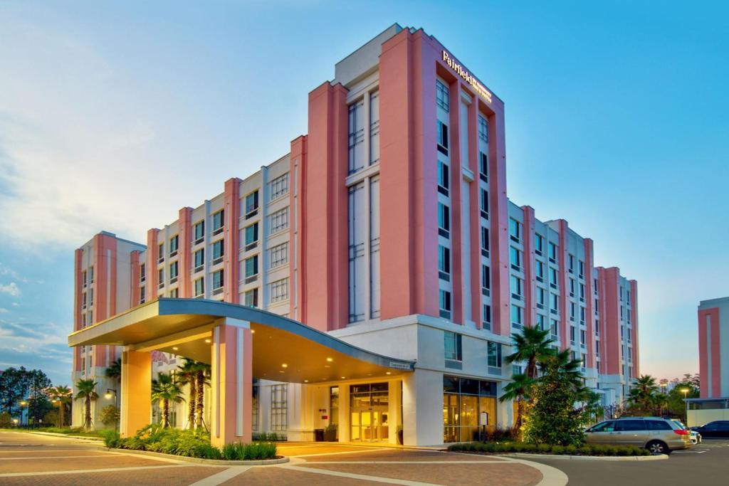 un grand bâtiment rouge avec un parking dans l'établissement Fairfield by Marriott Inn & Suites Orlando at FLAMINGO CROSSINGS® Town Center, à Orlando