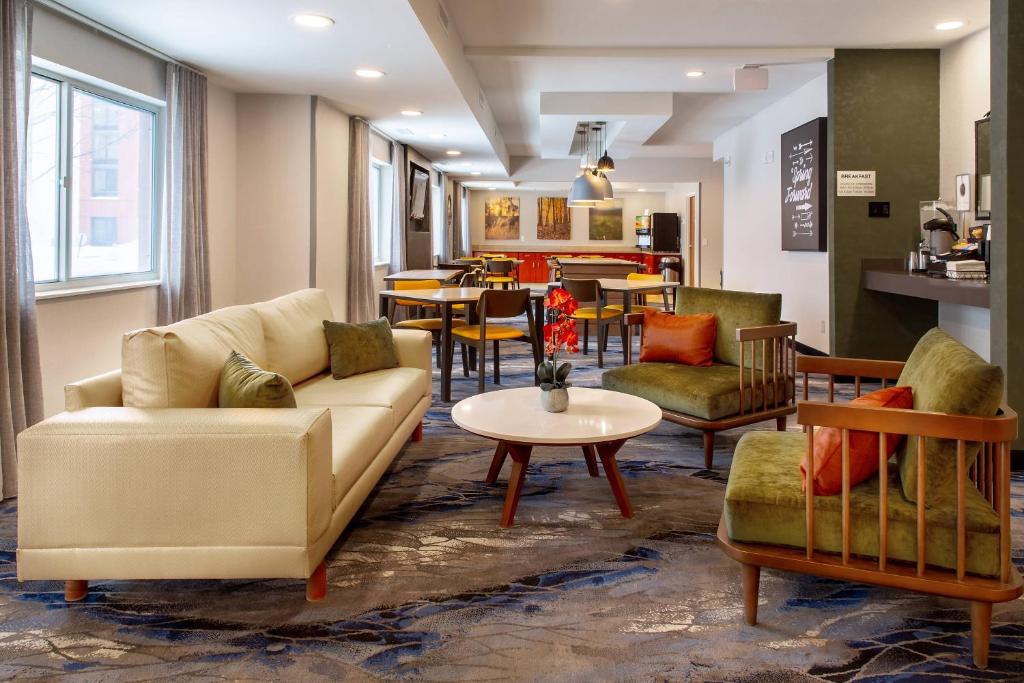 a living room with a couch and chairs and a table at Fairfield Inn & Suites Minneapolis Eden Prairie in Eden Prairie