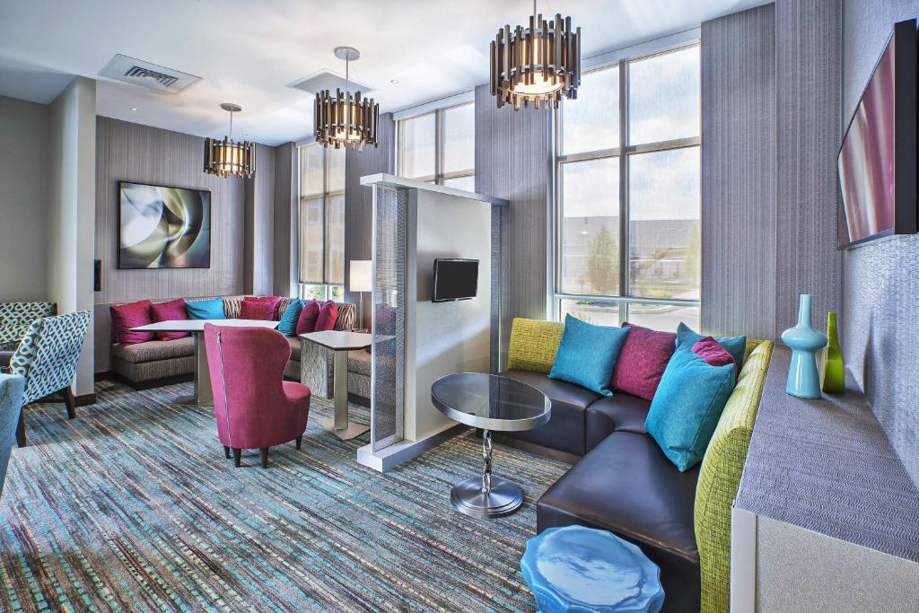 a living room with a couch and a table at Residence Inn Rochester Henrietta in Rochester