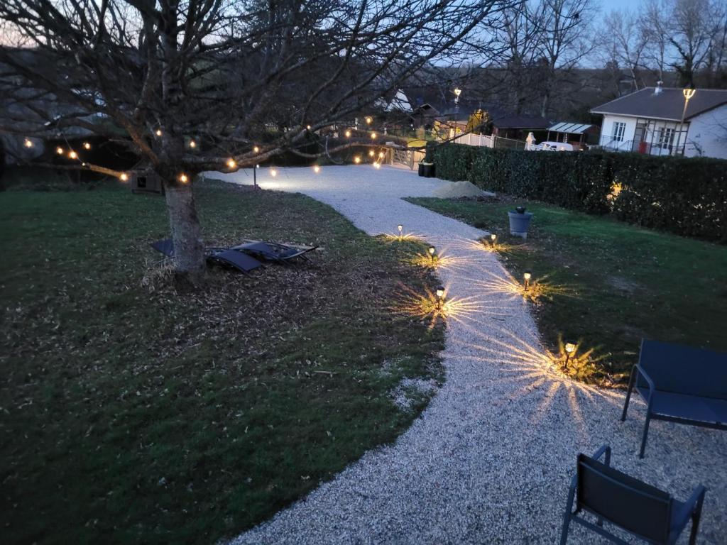 a walkway with lights in a yard at night at La paillote idyllique in Faverolles-sur-Cher