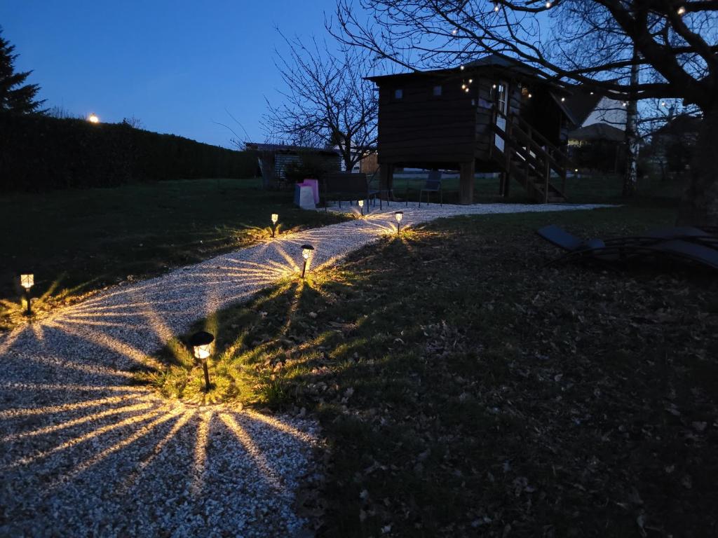 a pathway with lights in the grass at night at La paillote idyllique in Faverolles-sur-Cher