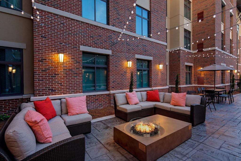 een patio met banken en een tafel en een bakstenen gebouw bij Residence Inn by Marriott Charleston Summerville in Summerville