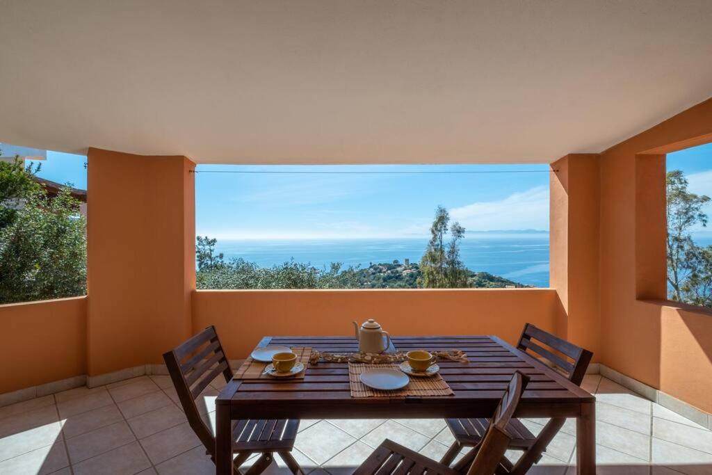 a table and chairs in a room with a large window at Casa Delle Pleiadi in Torre delle Stelle