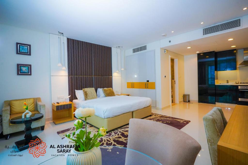 a bedroom with a bed and a living room at Al Ashrafia Saray - Extraordinary Studio in Canal View in Dubai
