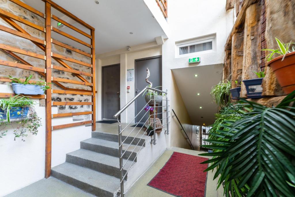 a staircase in a building with plants at L&#39;Oasis Montparnasse in Paris