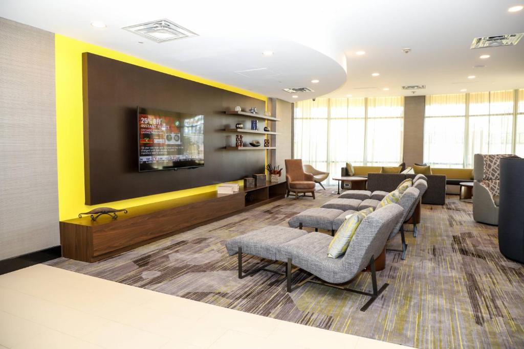 a waiting room with a row of chairs and a waiting room at Courtyard by Marriott Toronto Brampton in Brampton