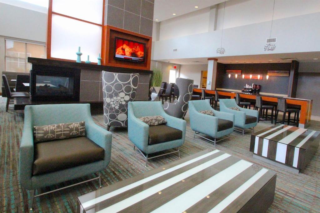 a waiting room with chairs and a fireplace at Residence Inn Newport News Airport in Newport News