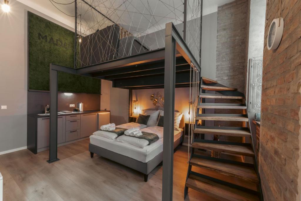 a bedroom with a bunk bed and a staircase at MADU-Living Vienna - Egon in Vienna