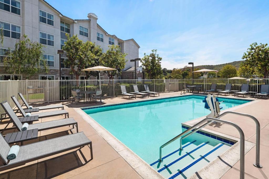 a swimming pool with lounge chairs and a hotel at Residence Inn San Diego Rancho Bernardo Scripps Poway in Sabre Springs