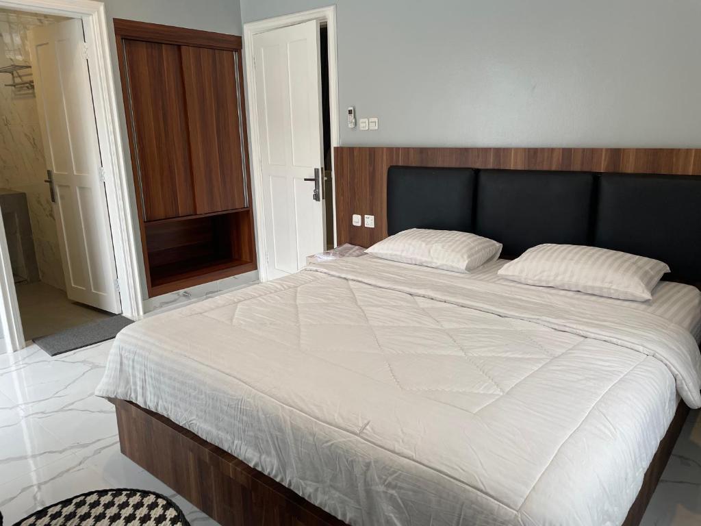 Postel nebo postele na pokoji v ubytování Eton Asia Villas-Kota Bunga