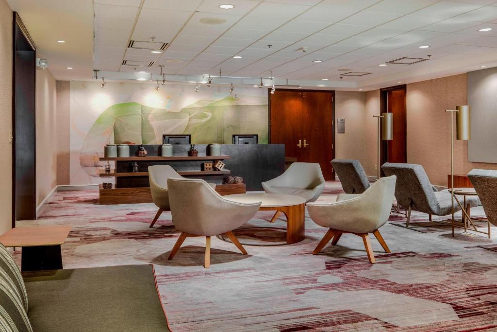 a lobby with chairs and a table and a waiting room at Courtyard by Marriot Cranbury South Brunswick in Cranbury