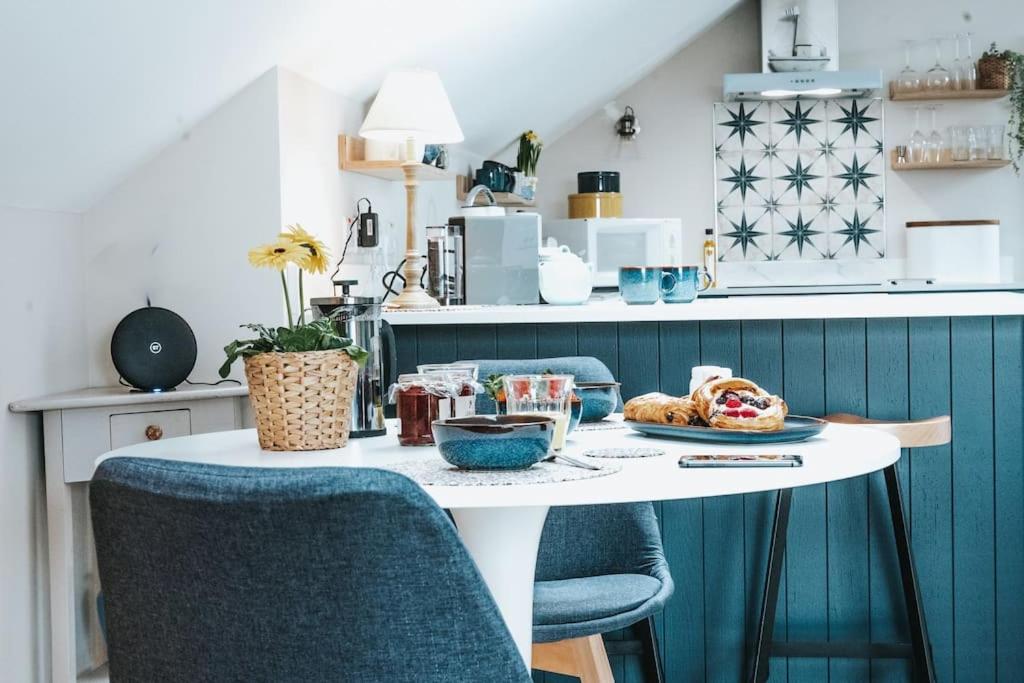 a kitchen with a table with a plate of food on it at The Sea Loft Castlerock. in Castlerock