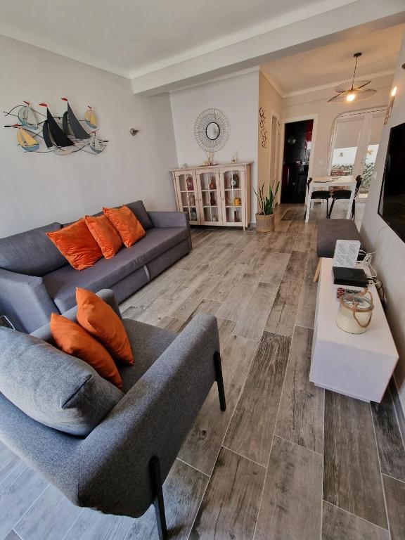 a living room with two couches and a table at Casa Pescador in Carvoeiro