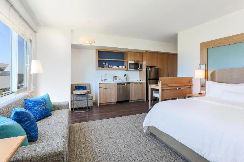 a hotel room with a bed and a kitchen at Element Ontario Rancho Cucamonga in Ontario