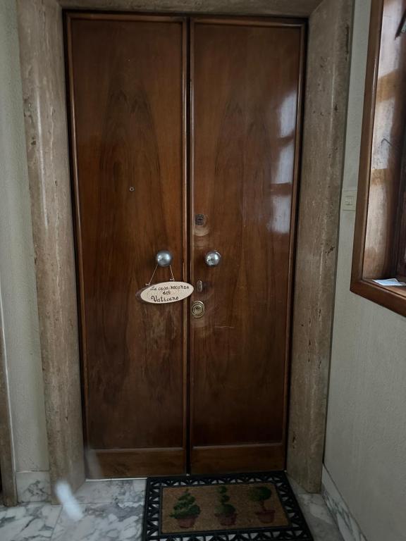 a large wooden door with a sign on it at La casa vacanza del Vaticano in Rome