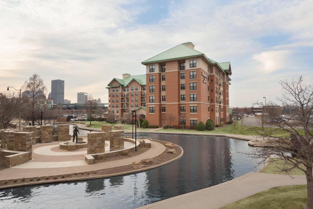 a building with a river in front of it at Residence Inn by Marriott Oklahoma City Downtown/Bricktown in Oklahoma City