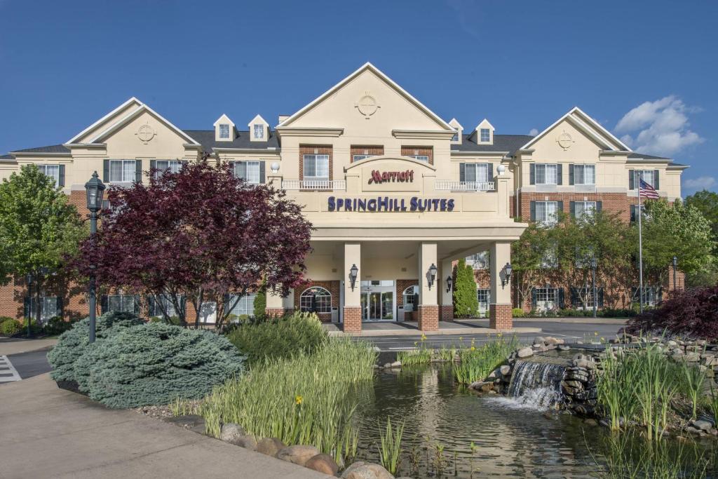 a hotel with a pond in front of a building at Springhill Suites by Marriott State College in State College
