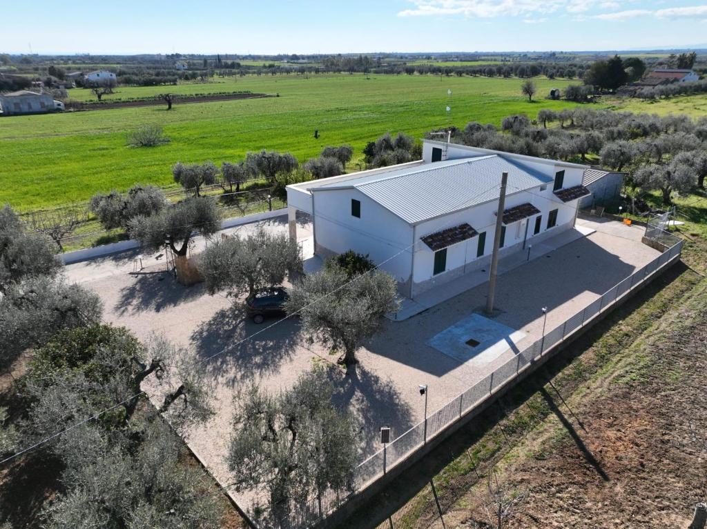 an aerial view of a white house in a field at Casa Vacanze Maurella in Marconia