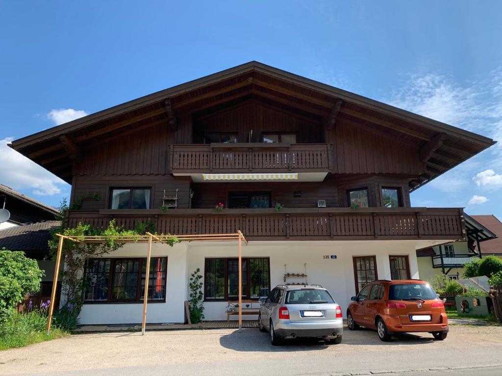 a building with two cars parked in front of it at Appartements Mair in Strobl in Strobl