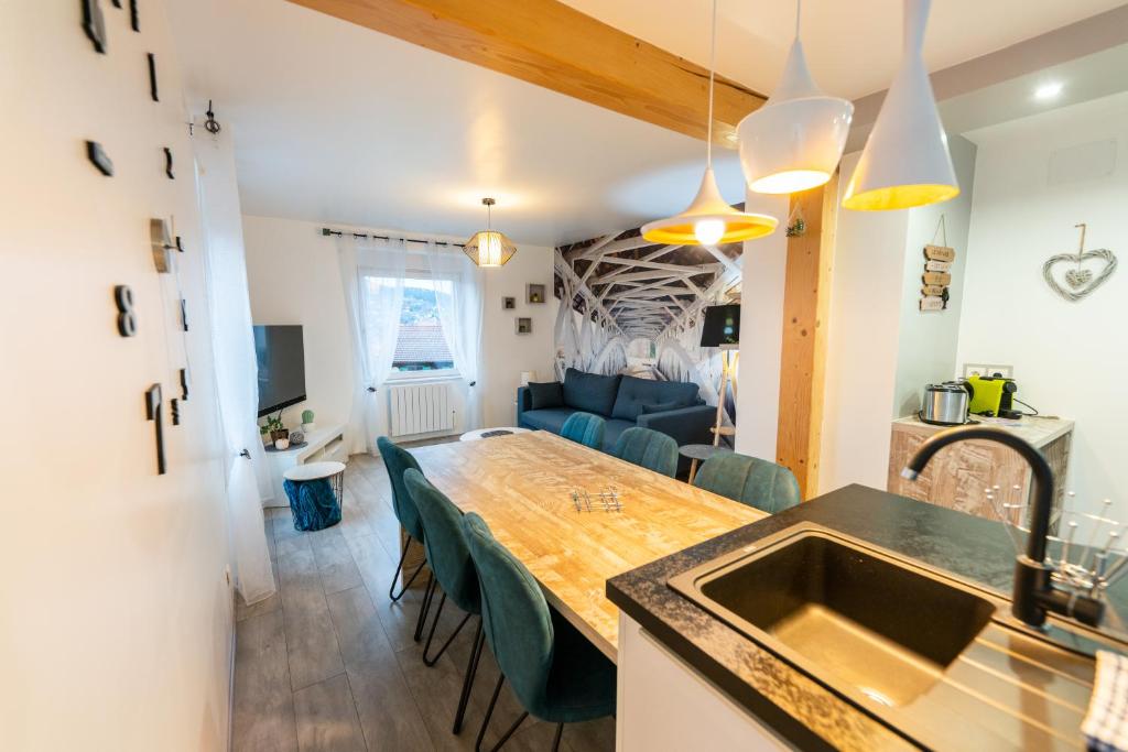 a kitchen and dining room with a table and a couch at Gîte l&#39;Améthyste 3 appartements in Gérardmer