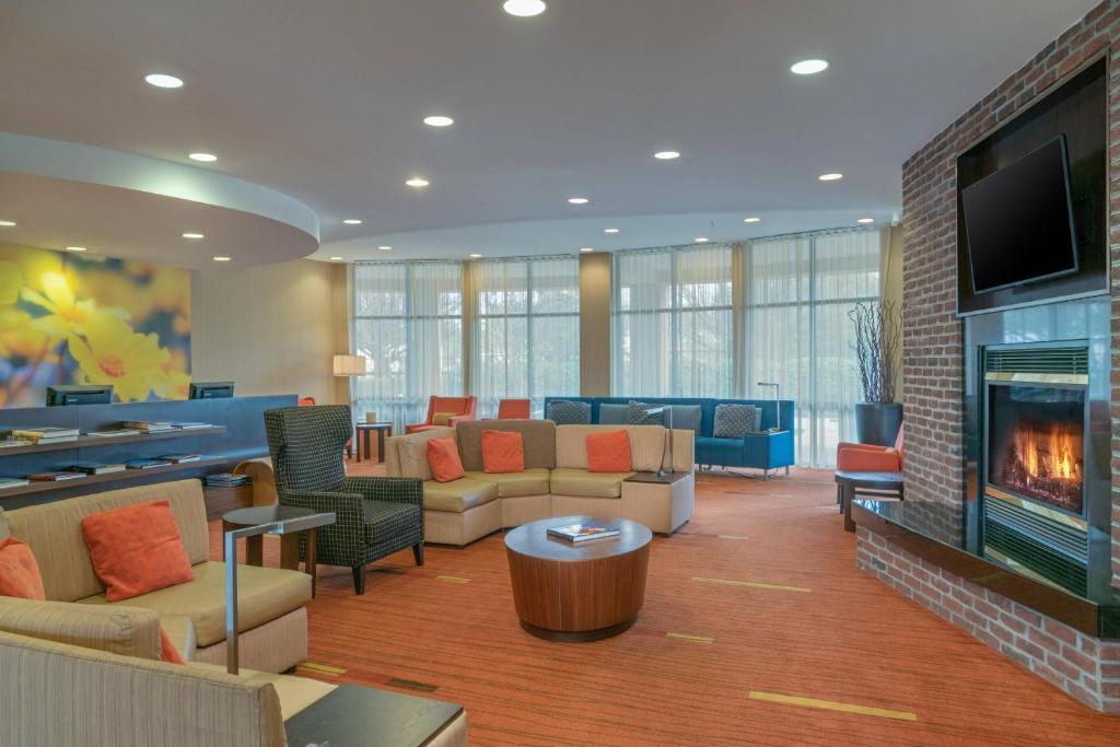 a lobby with couches and a fire place at Courtyard by Marriott Salisbury in Salisbury