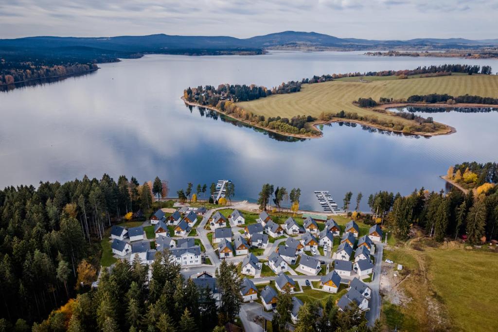 an aerial view of a resort on a lake at Deluxe Apartment Lipno - Lake Side Village, Frymburk nad Vltavou in Frymburk