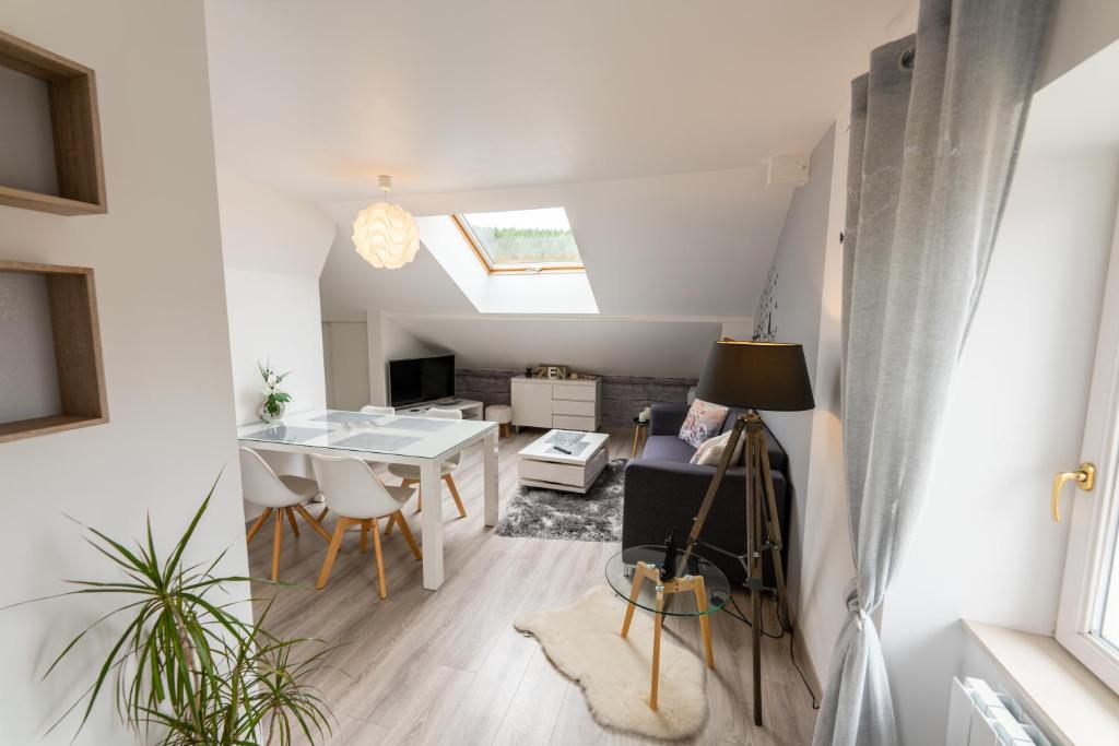 a living room and dining room with a skylight at Gîte l&#39;Améthyste 3 appartements in Gérardmer