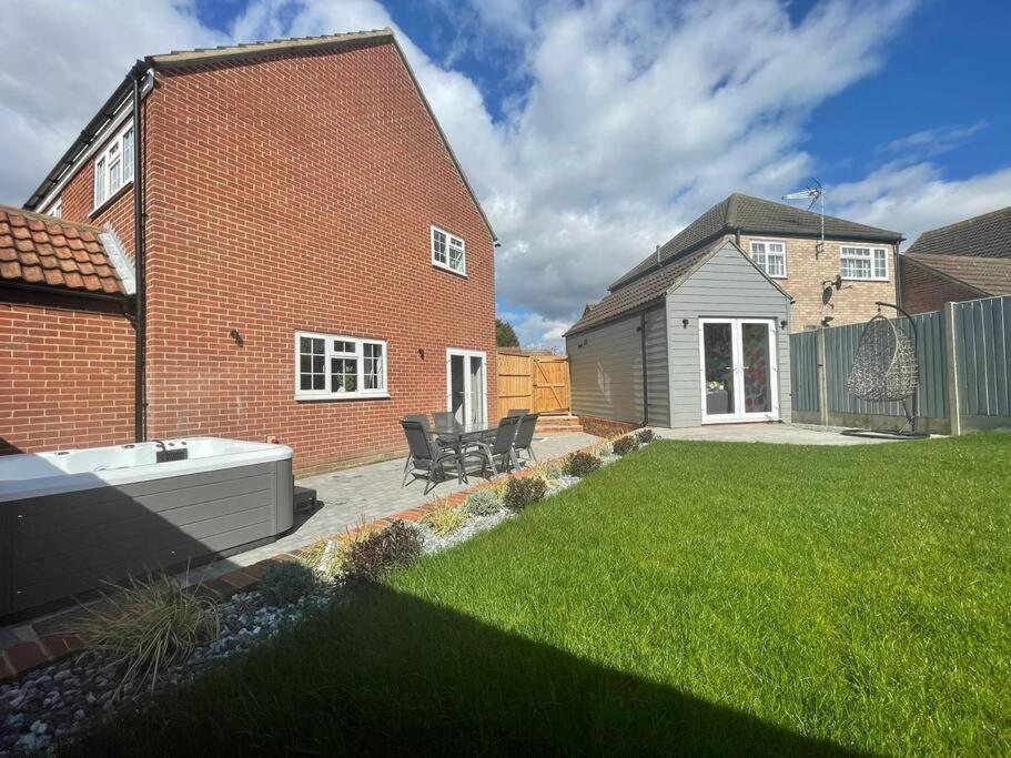 a yard with a brick house with a bath tub at DaisyChain Getaways at Chaney Rd in Wivenhoe