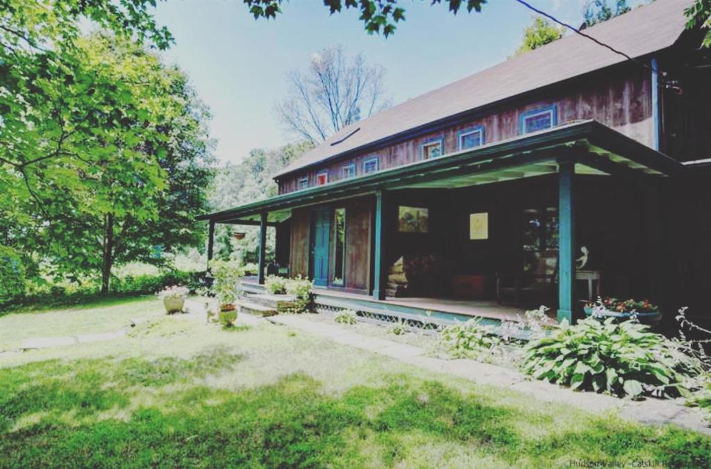 a large house with a porch and a yard at Wonderful Farm Escape With Swim Creek & Hiking Trails in Saugerties