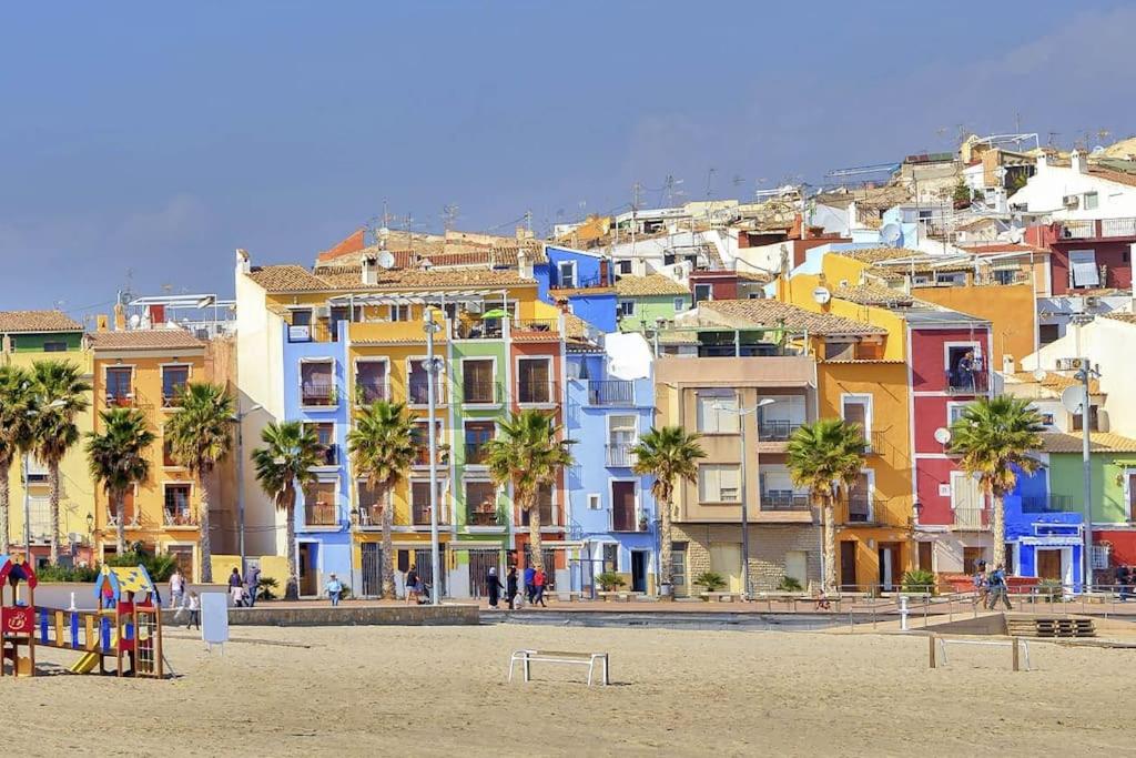 a group of colorful buildings on a beach at Loft Playa Villajoyosa in Villajoyosa