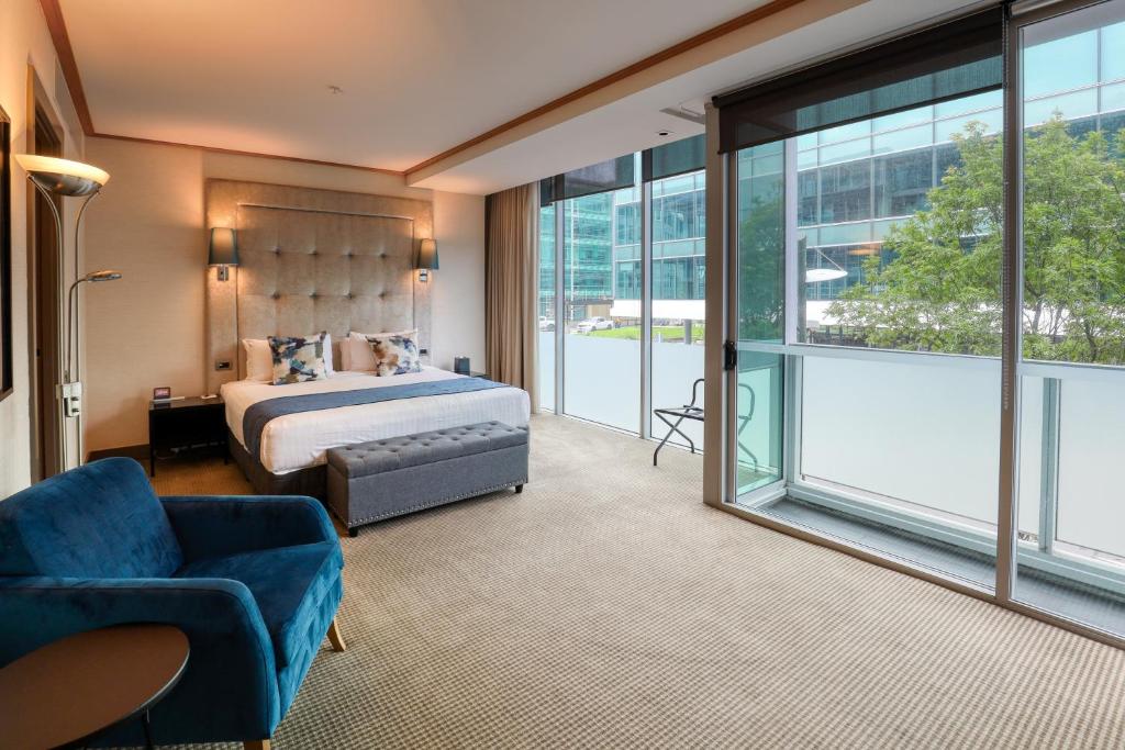 a hotel room with a bed and a large window at Marsden Viaduct in Auckland